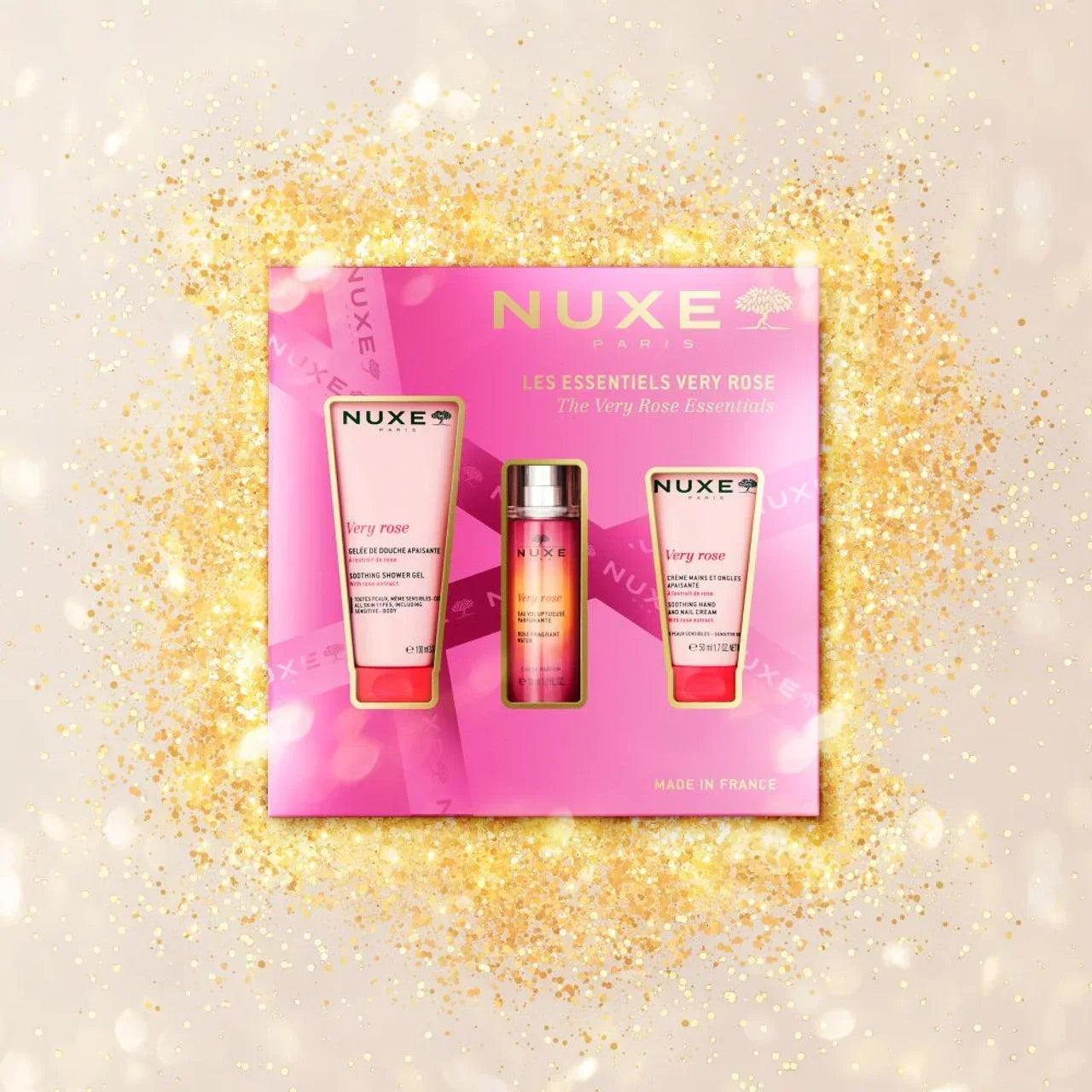 Nuxe Very Rose Essentials skincare set with shower gel and lotion, pink packaging, gold sparkle background, available at Goldfarmaci Albania