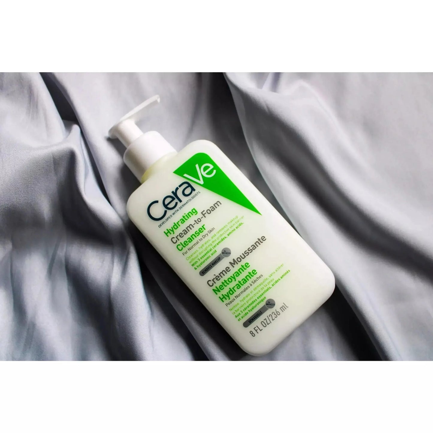 CeraVe Hydrating Cream-to-Foam Cleanser bottle on soft gray fabric, skincare product