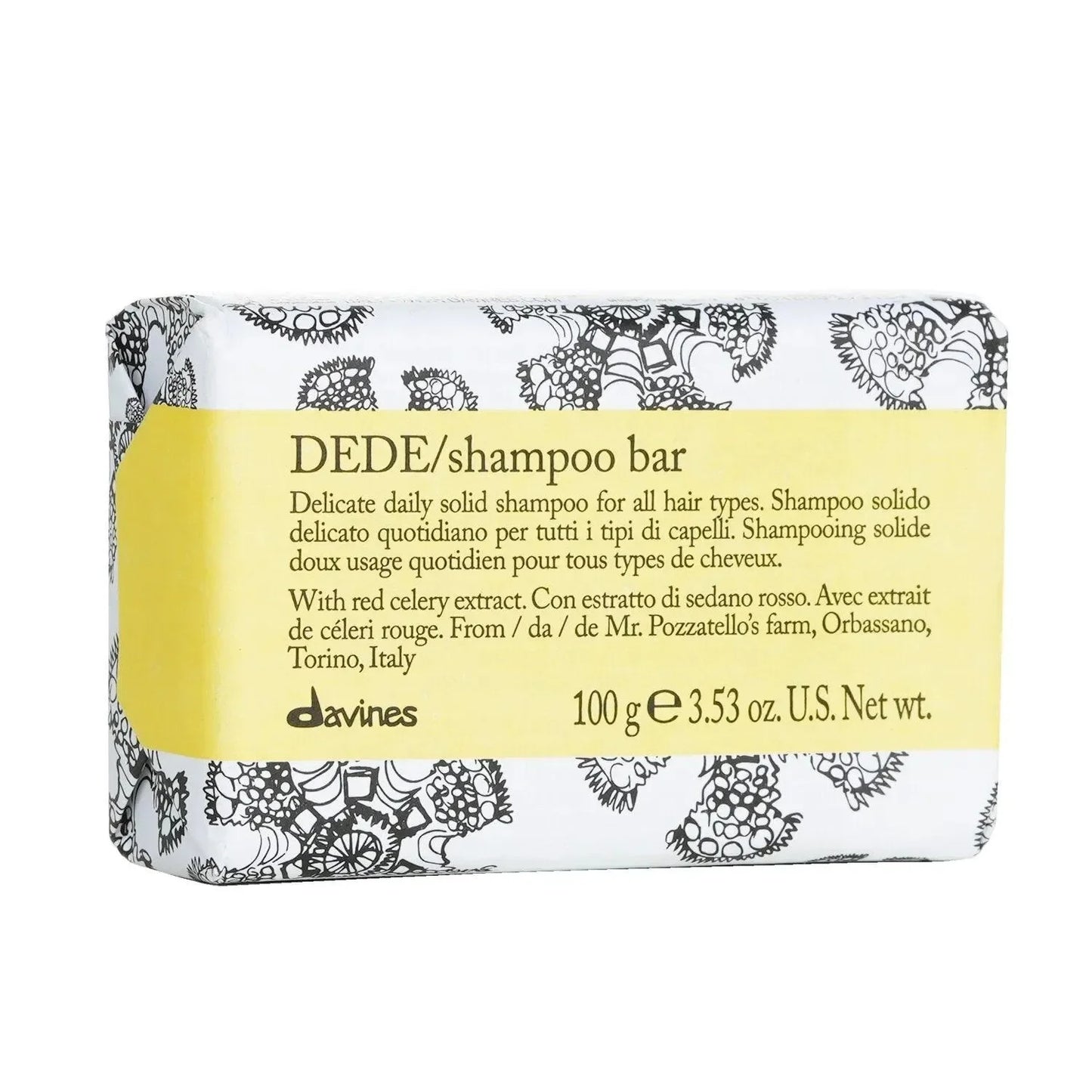 DEDE shampoo bar for all hair types, wrapped in white paper with black floral designs