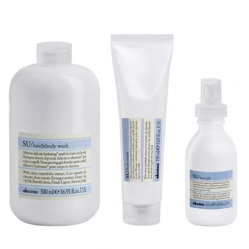 Set of Davines SU hair and body wash products, including bottle, tube, and spray, for haircare and skincare.