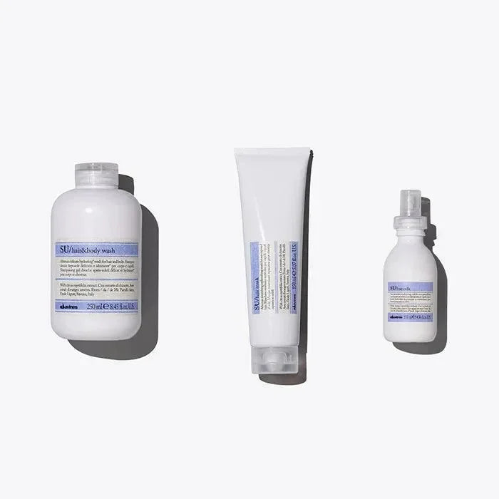 Davines SU hair and body care products set with bottle, tube, and spray on white background