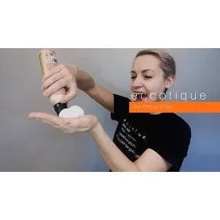 Person dispensing volumizing mousse onto hand for hair styling