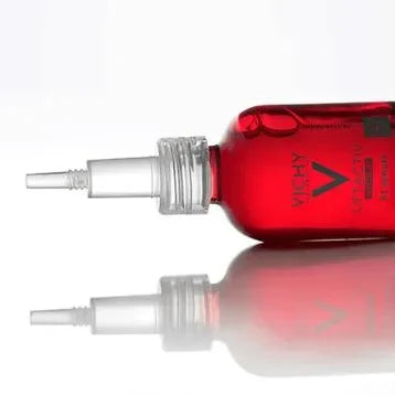 Red Vichy Liftactiv serum bottle with applicator tip on reflective white surface