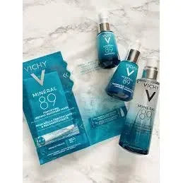Vichy Mineral 89 hyaluronic acid gel and serum bottles on marble background