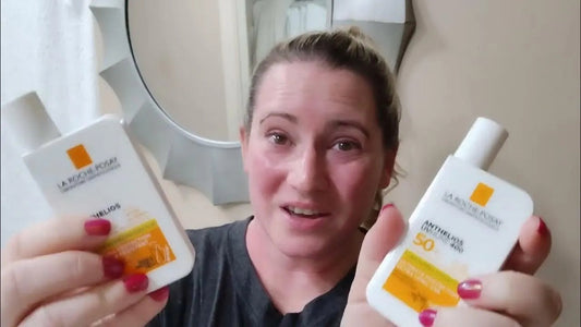 Woman holding La Roche-Posay Anthelios sunscreen bottles in a bathroom, Goldfarmaci skincare