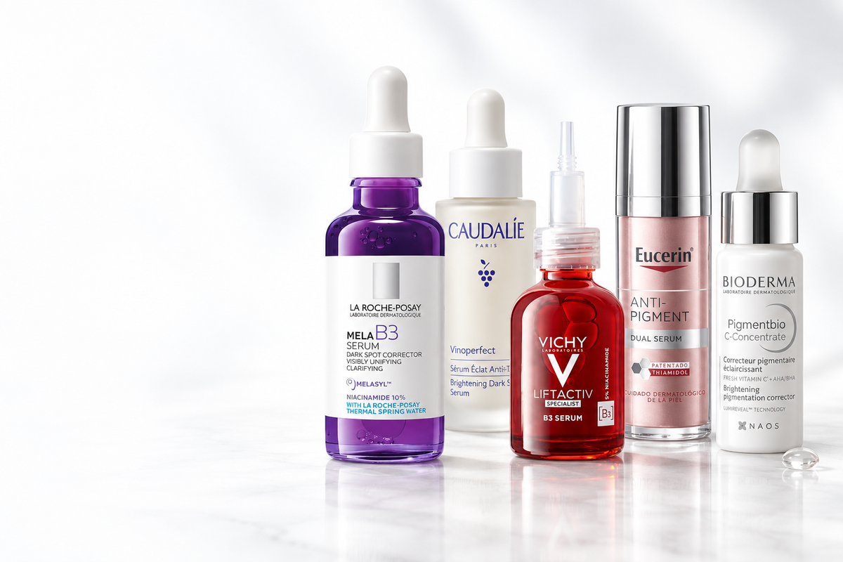 Five selected dark-spot serums in an ice-white studio
