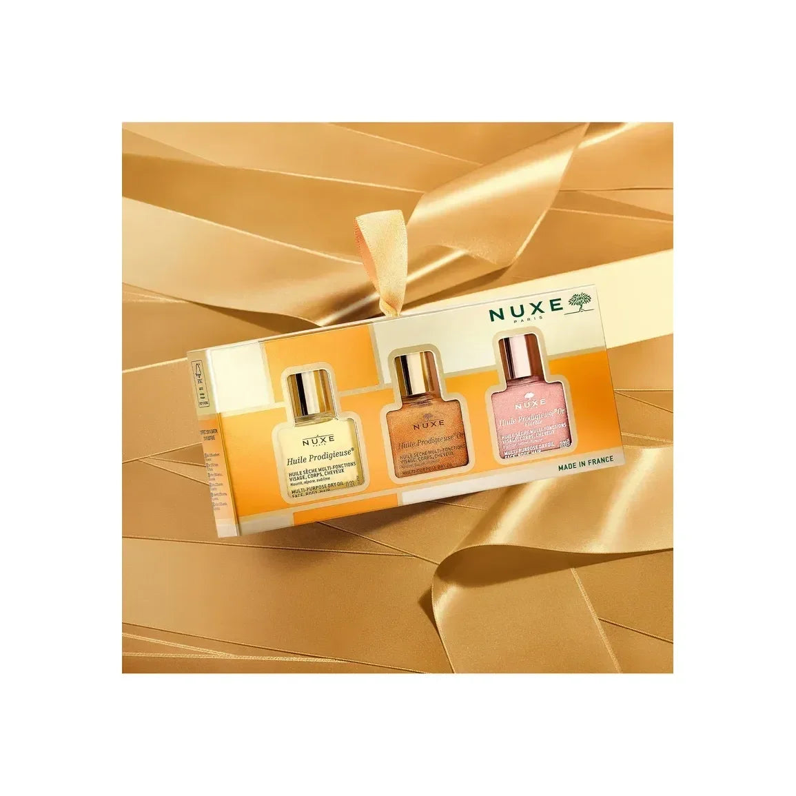 Nuxe The 3 Prodigieux skincare set on gold satin, featured at Goldfarmaci online pharmacy.