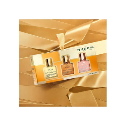 Nuxe The 3 Prodigieux skincare set on gold satin, featured at Goldfarmaci online pharmacy.