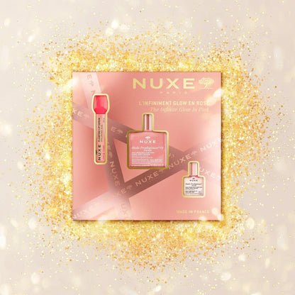 Nuxe The Infinite Glow in Pink set on a sparkling gold background, featured at Goldfarmaci