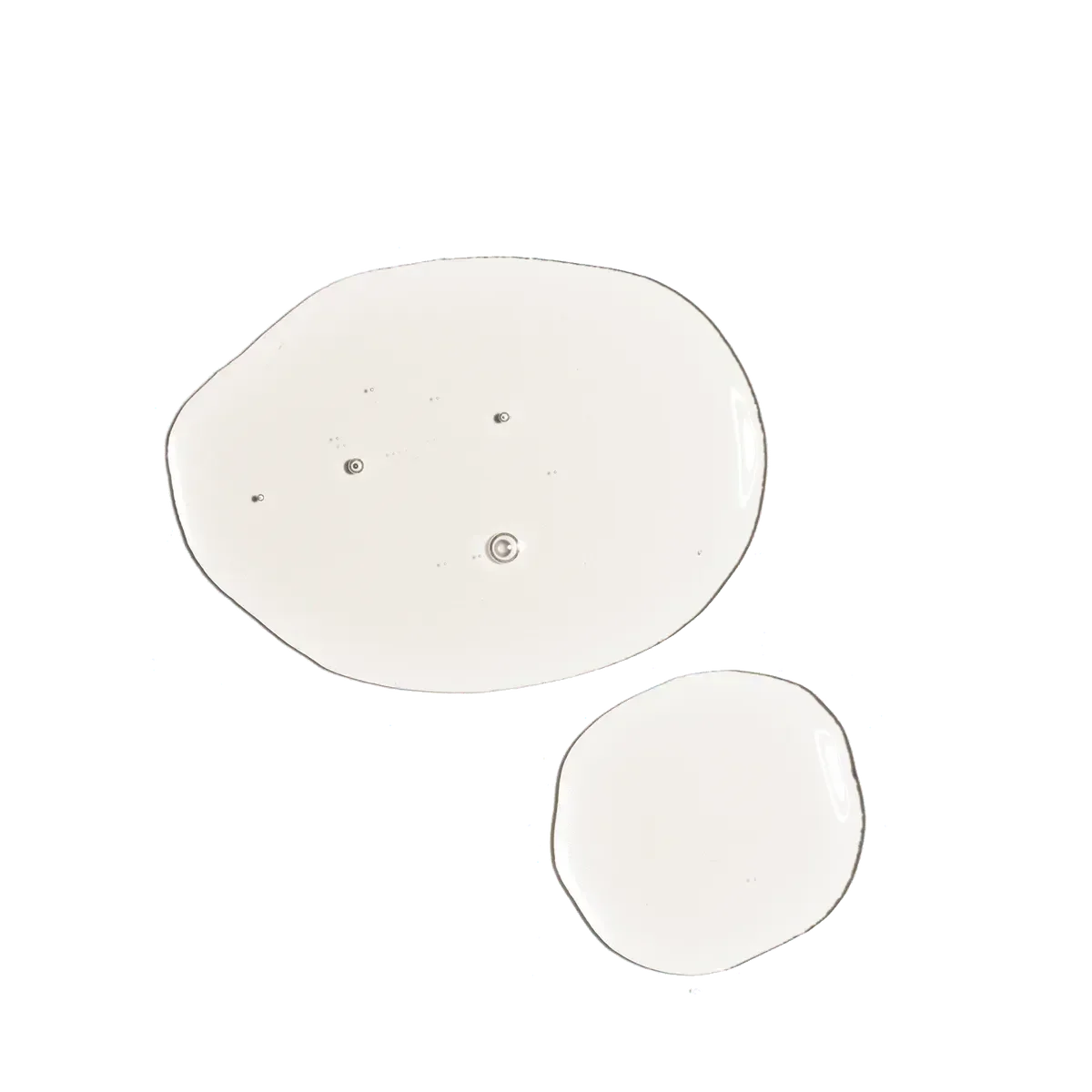 Two drops of 100% organic cold-pressed Moroccan argan oil on a flat surface, Goldfarmaci skincare