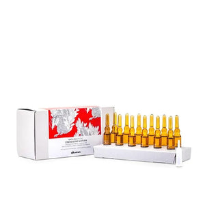 Hair care ampoules in brown glass vials with a white and red packaging box