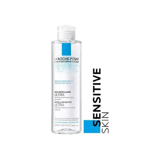 Micellar water bottle for sensitive skin with blue label and clear liquid on white background